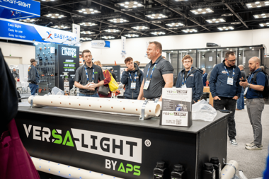 APS team demonstrating the Versa-Light UV curing system at WWETT show showcasing UV pipe rehabilitation equipment and CIPP solutions.